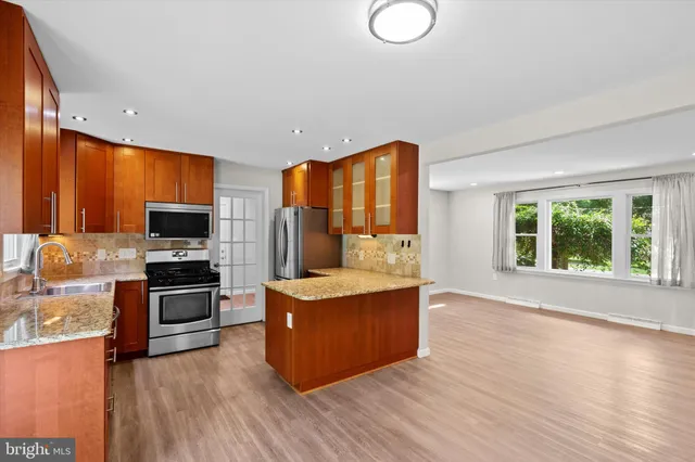 a kitchen with stainless steel appliances a stove top oven and sink