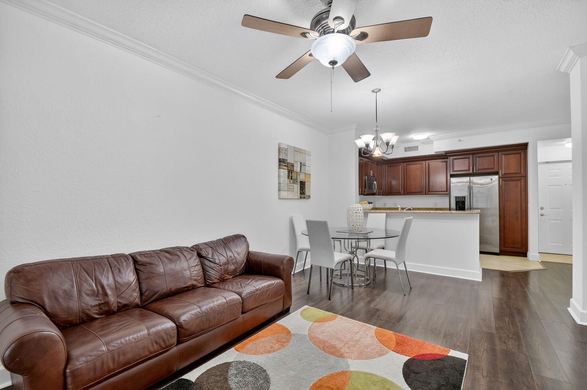 3110 Renaissance Way, Unit 110 Boynton Beach, FL 33426 - Photo 12 of 45 a living room with furniture kitchen view and a chandelier