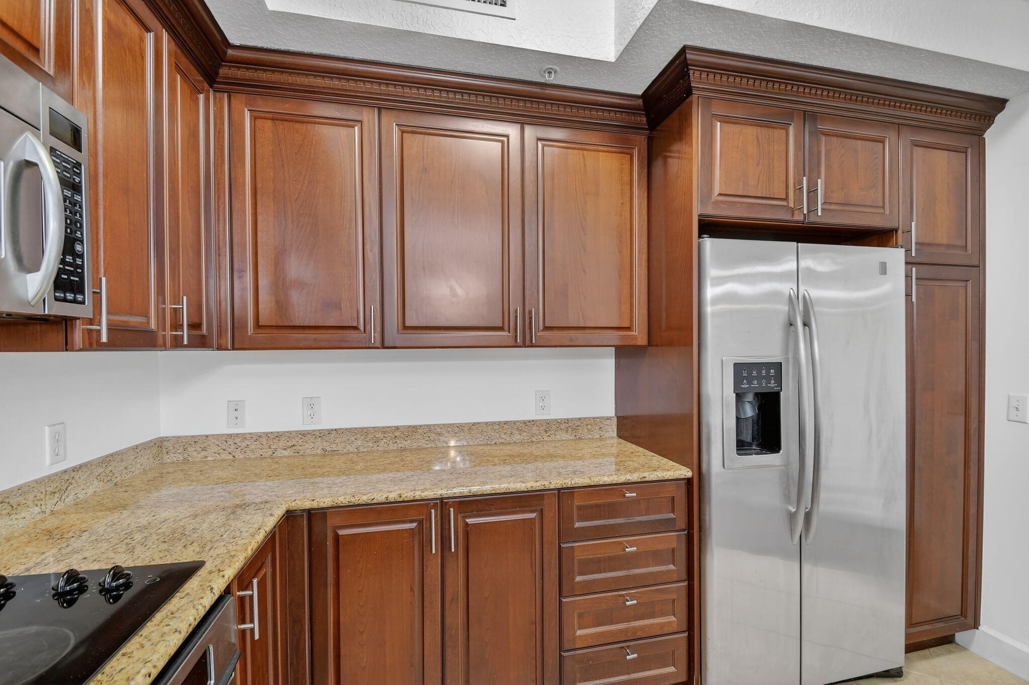 3110 Renaissance Way, Unit 110 Boynton Beach, FL 33426 - Photo 14 of 45 a kitchen with granite countertop stainless steel appliances and cabinets