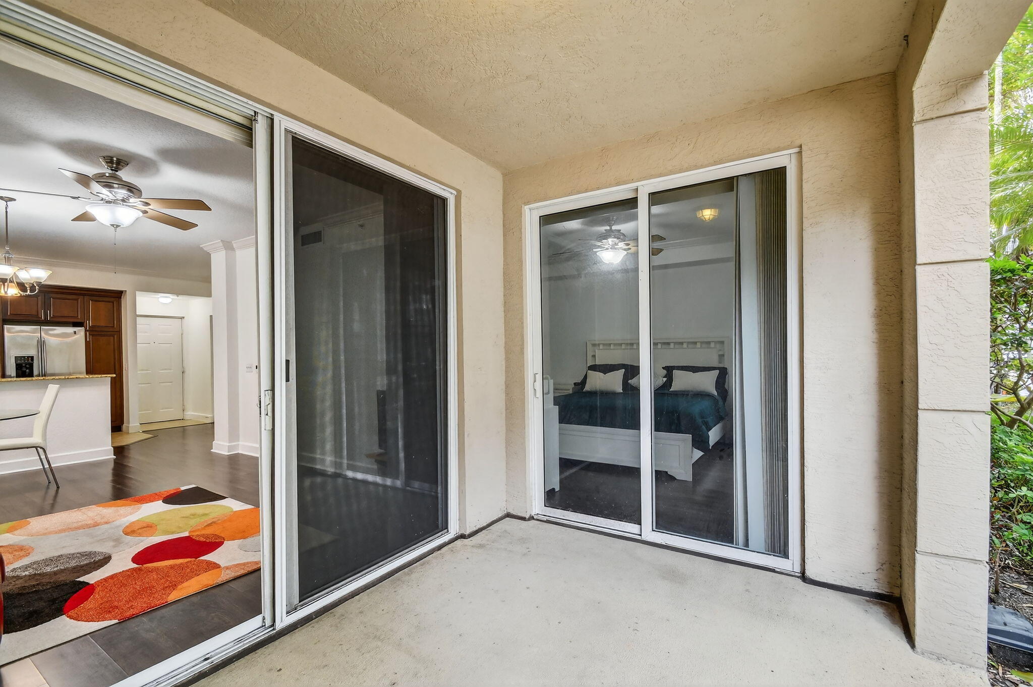 3110 Renaissance Way, Unit 110 Boynton Beach, FL 33426 - Photo 20 of 45 a view of a bedroom with a bed and wooden floor