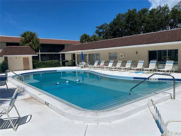 a view of a patio with swimming pool table and chairs
