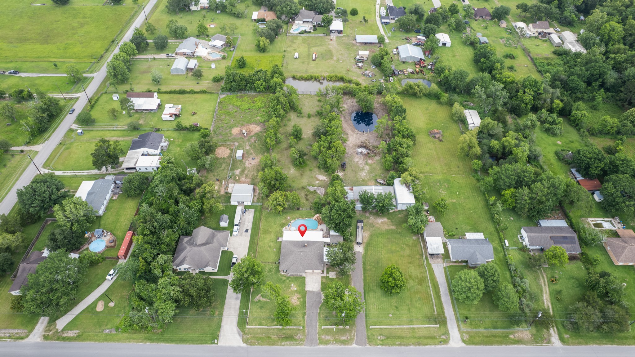 15602 Fir Road Santa Fe, TX 77517 - Photo 1 of 42 Expansive aerial view highlighting the property’s generous lot size, mature trees, private backyard oasis, and surrounding open space. This bird’s-eye perspective showcases the peaceful setting and ample room for outdoor living and recreation.