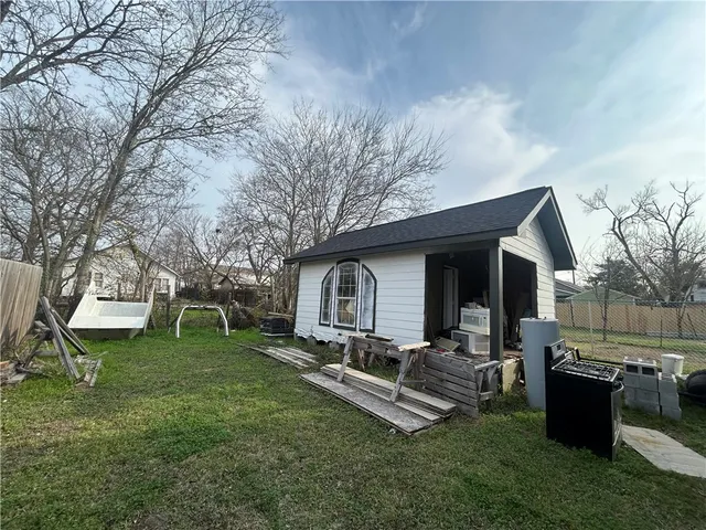 a view of a backyard with a garden and outdoor seating