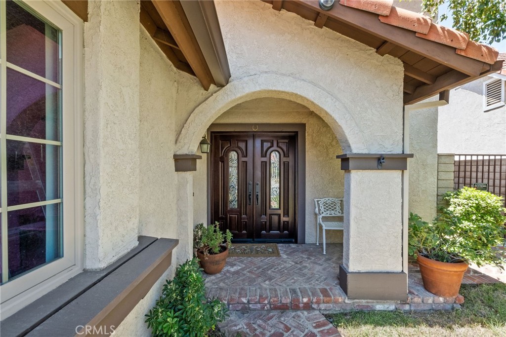 19800 Crystal Ridge Lane Porter Ranch, CA 91326 - Photo 1 of 1 a front view of a house with potted plants