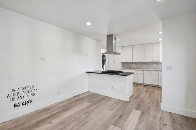 a kitchen with a stove a sink and a refrigerator