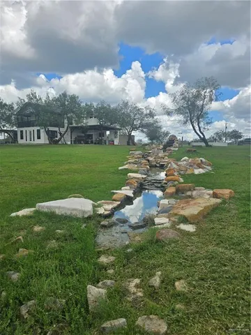 a view of a lake with lawn chairs