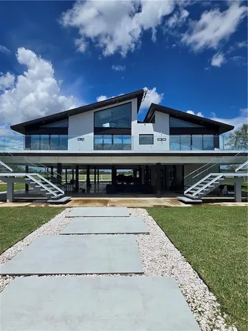 a view of a swimming pool with an outdoor seating and a yard