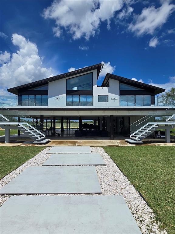 600 County Road 305 Encino, TX 78353 - Photo 5 of 28 a view of a swimming pool with an outdoor seating and a yard