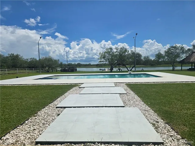 a view of a swimming pool and a yard