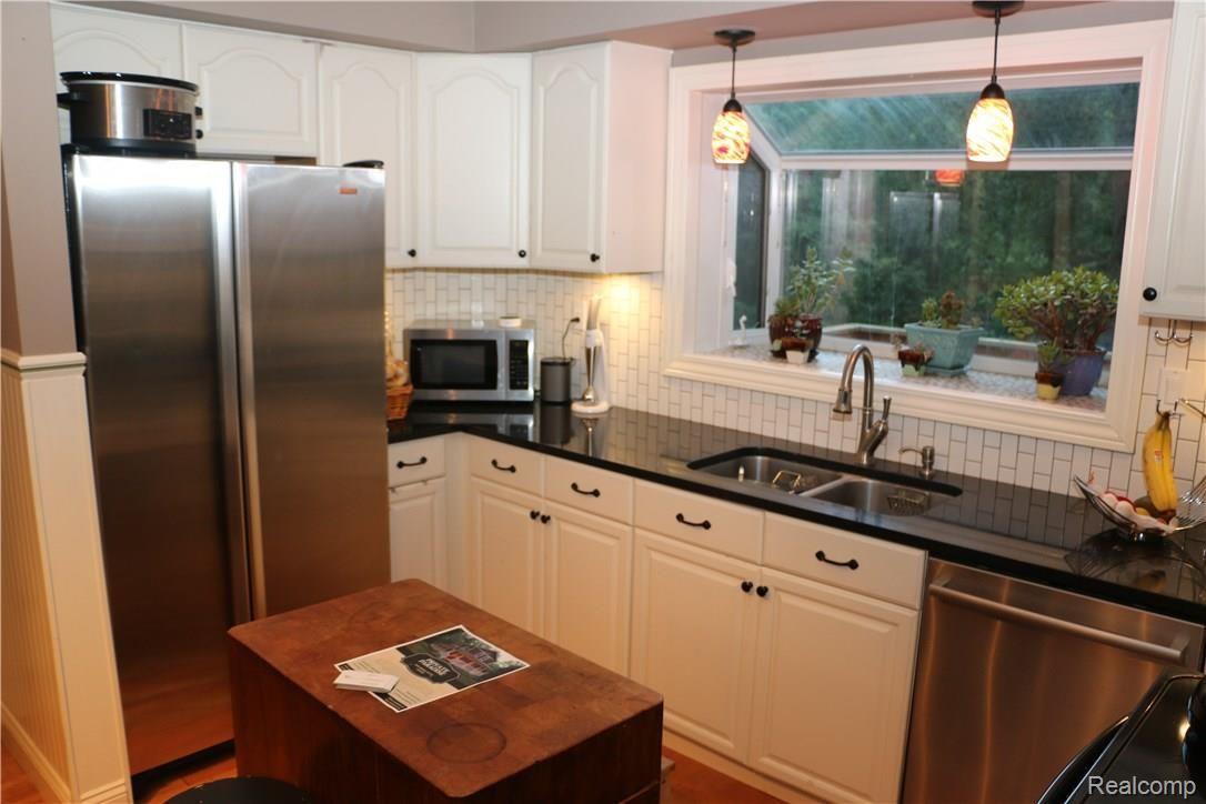 9404 Mabley Hill Road Fenton, MI 48430 - Photo 17 of 46 Kitchen with under-cabinet lighting and white cabinets.