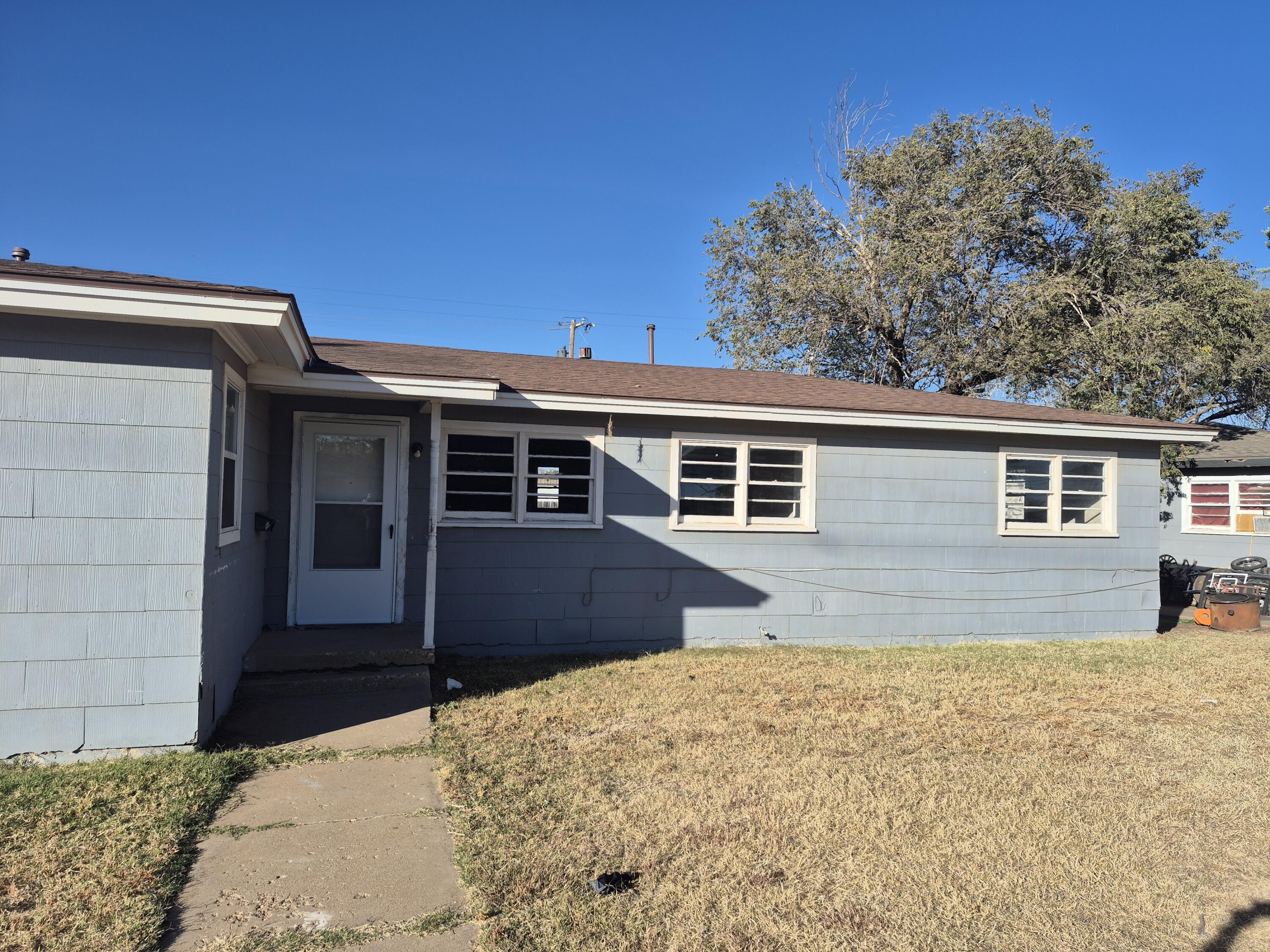 1714 42nd Street Lubbock, TX 79412 - Photo 1 of 16 front view of a house with a yard
