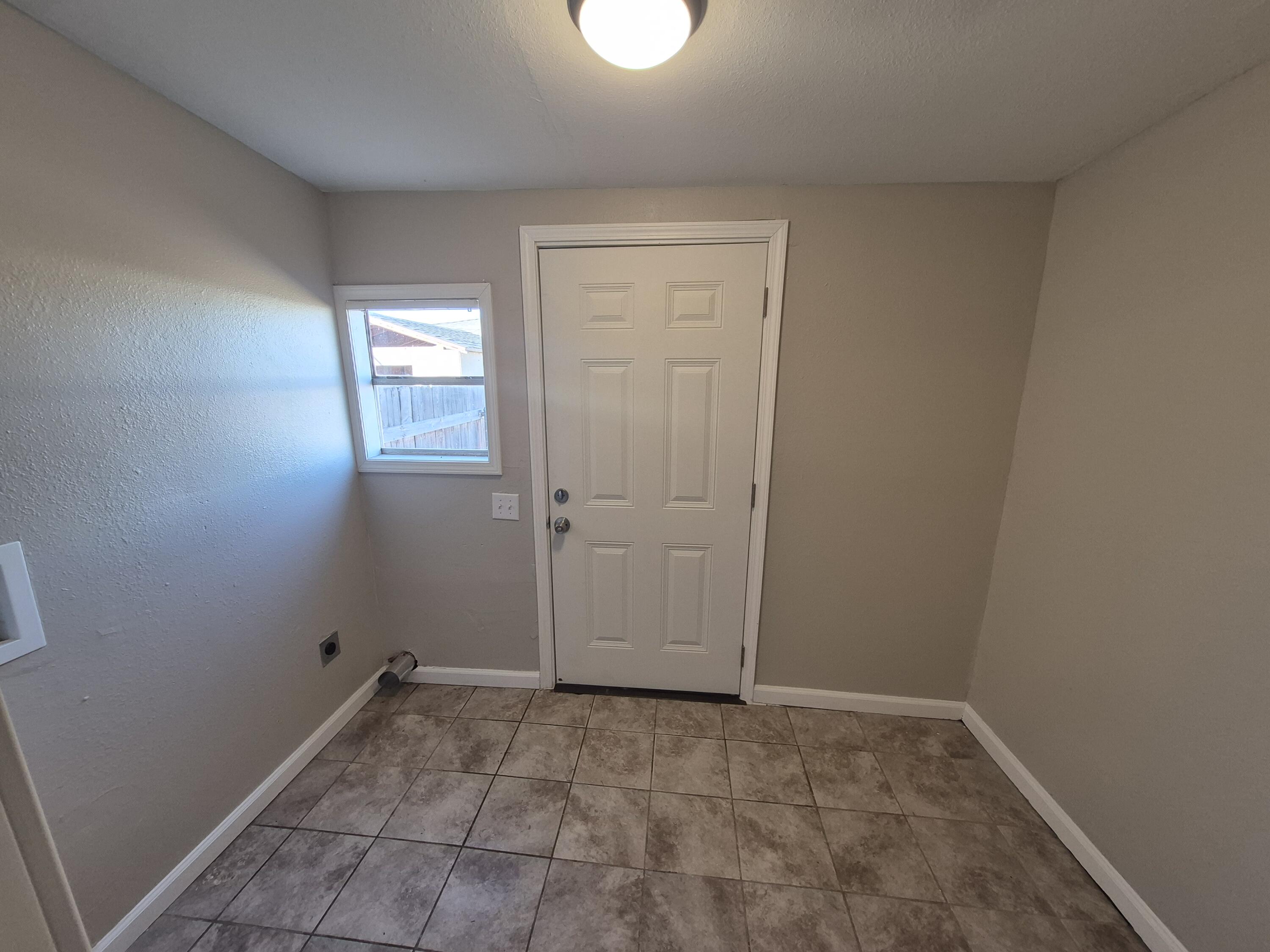 1714 42nd Street Lubbock, TX 79412 - Photo 7 of 16 an empty room with windows