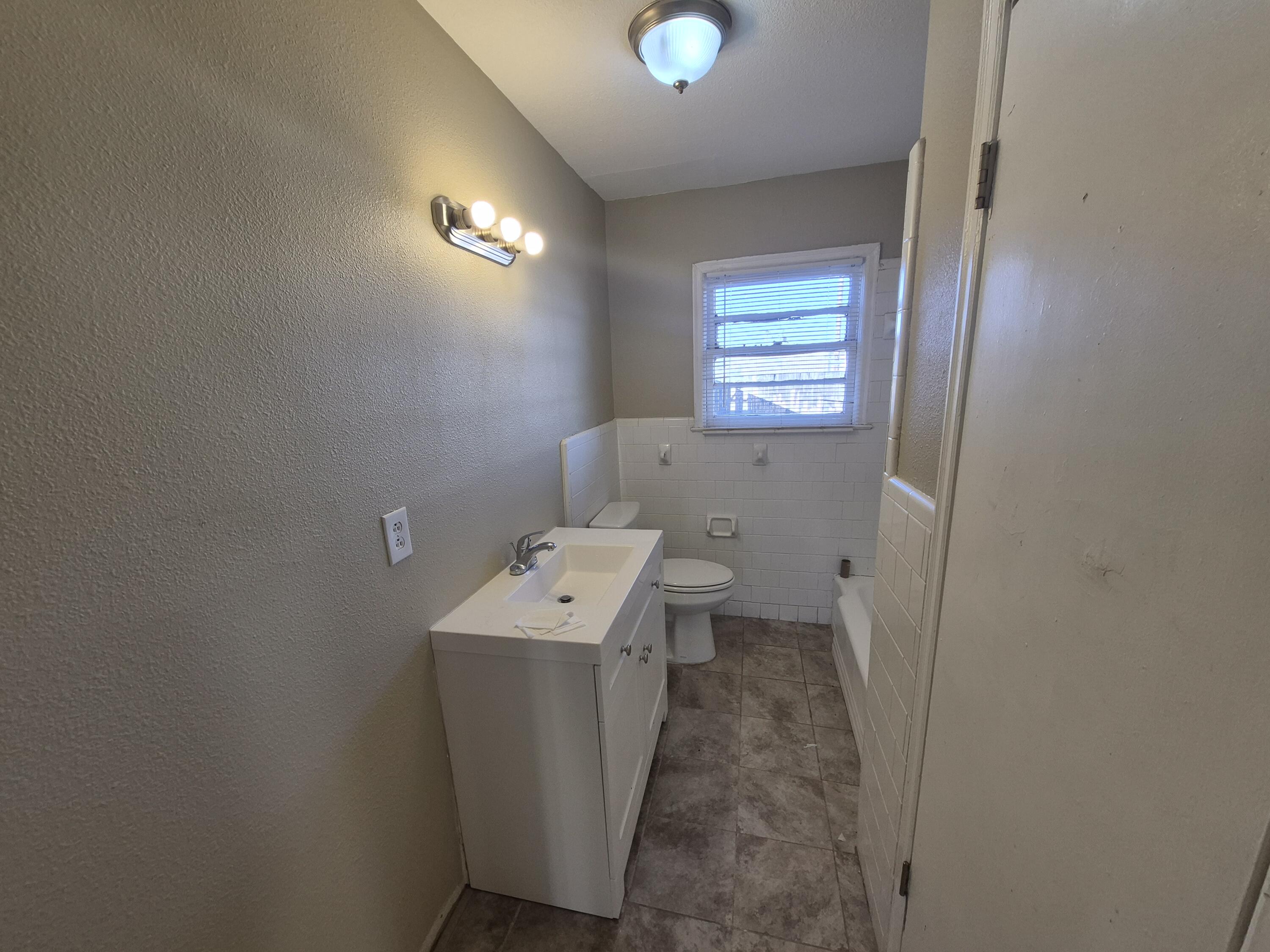 1714 42nd Street Lubbock, TX 79412 - Photo 9 of 16 a utility room with a window dryer and washer