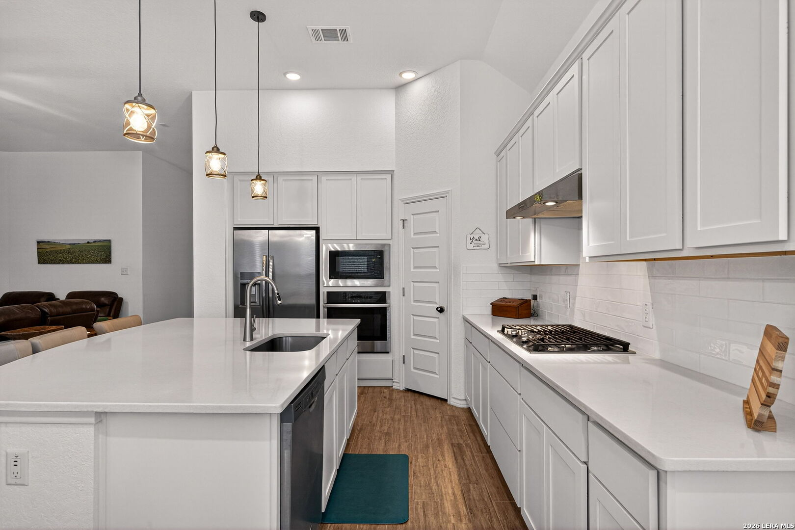 3146 Stokesay Bulverde, TX 78163 - Photo 13 of 30 a kitchen with kitchen island a sink stainless steel appliances and cabinets