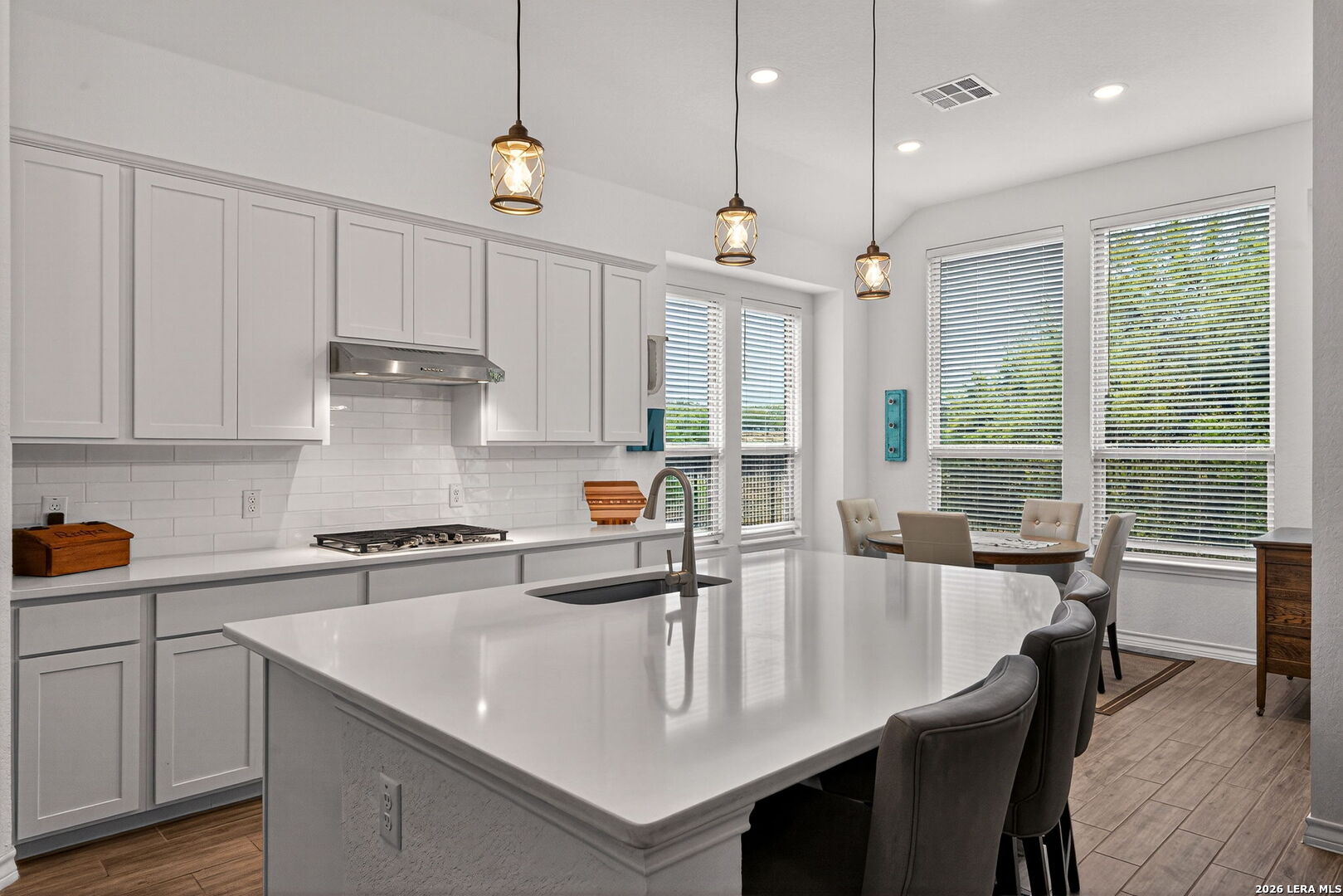3146 Stokesay Bulverde, TX 78163 - Photo 14 of 30 a kitchen with stainless steel appliances granite countertop a sink a stove and a refrigerator