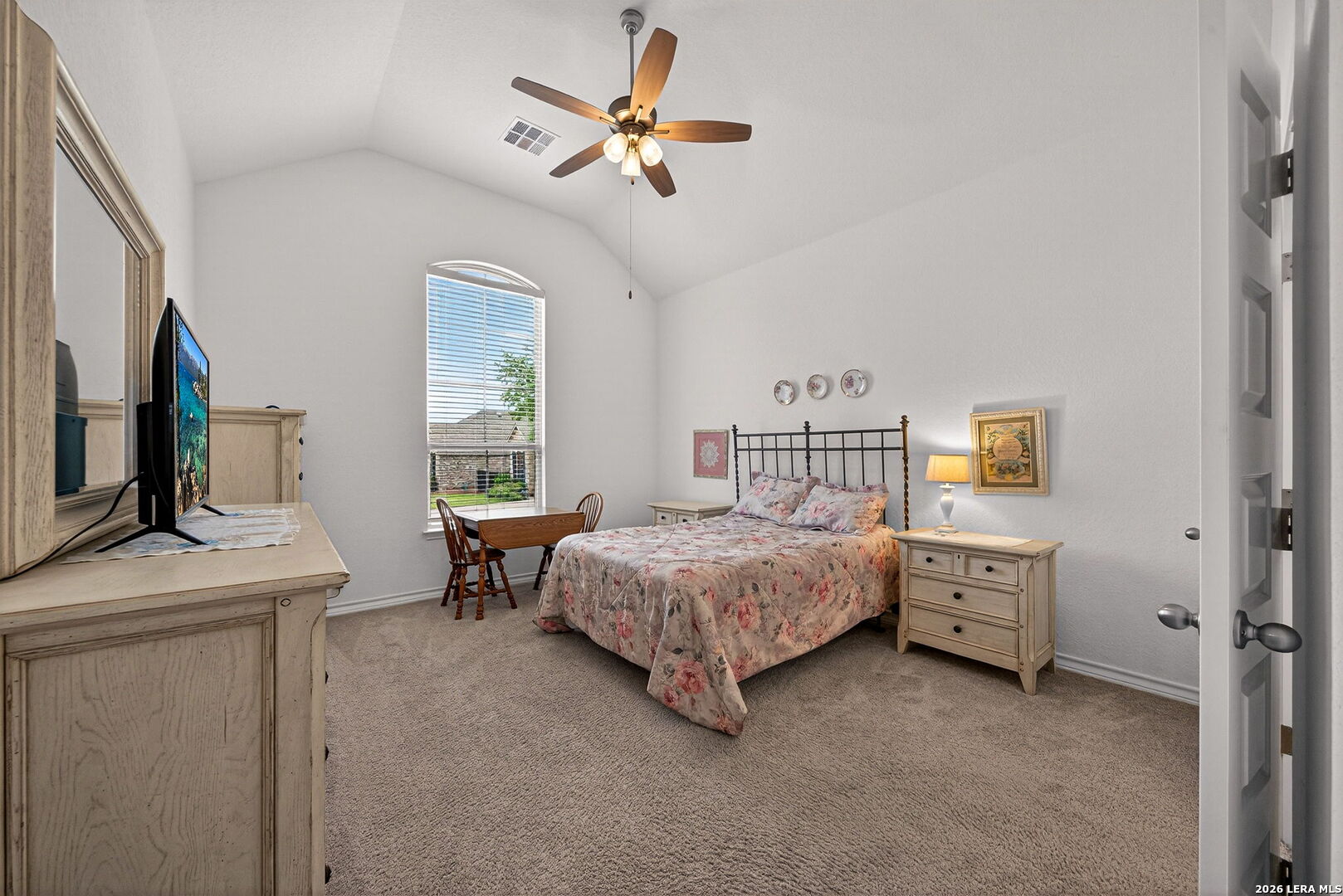 3146 Stokesay Bulverde, TX 78163 - Photo 22 of 30 a bedroom with a bed and a chandelier