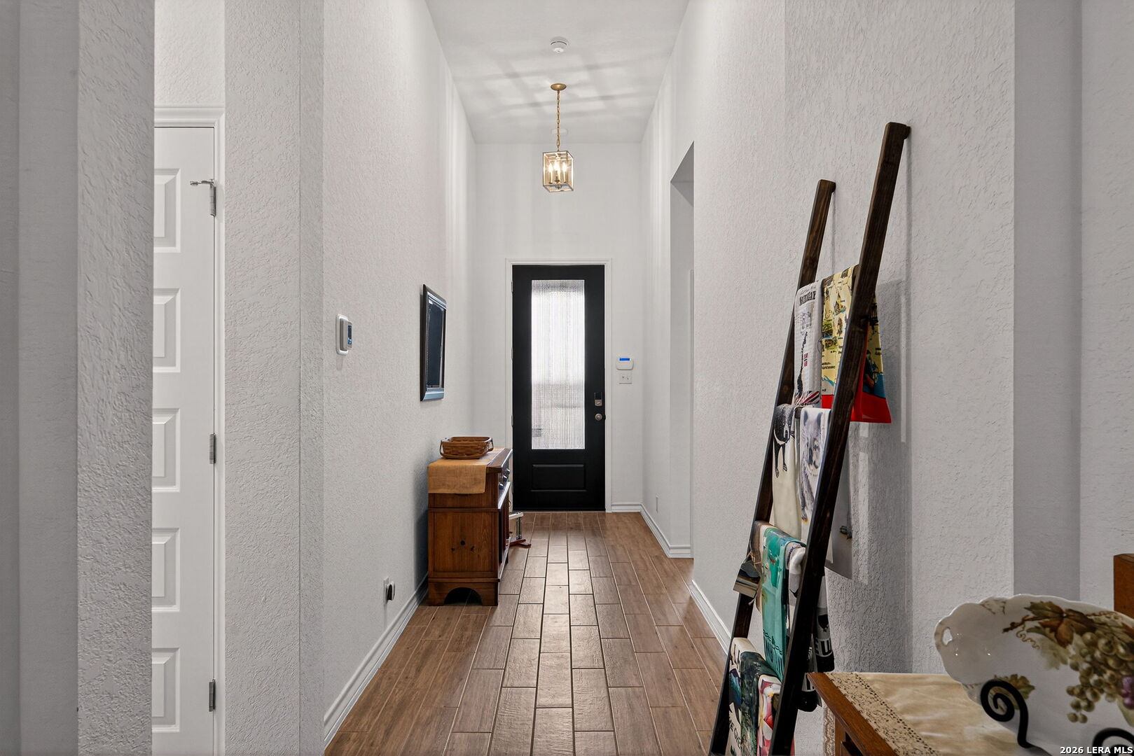 3146 Stokesay Bulverde, TX 78163 - Photo 3 of 30 a view of a hallway with wooden floor and stairs
