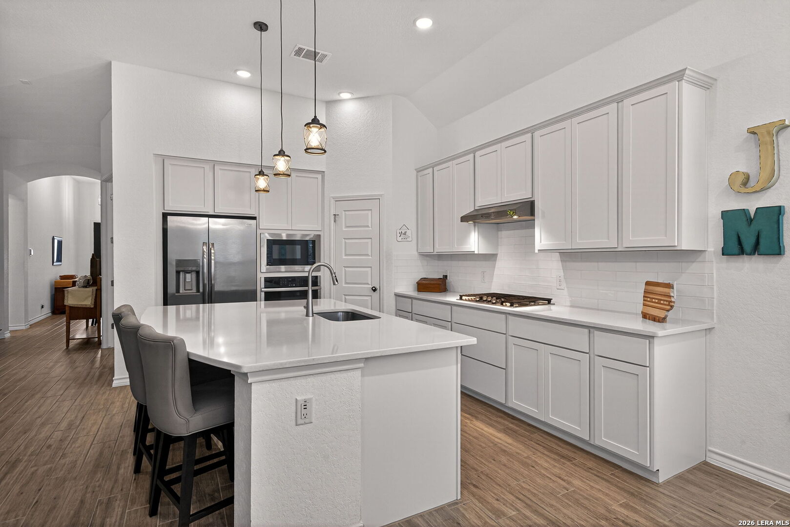 3146 Stokesay Bulverde, TX 78163 - Photo 5 of 30 a kitchen with a white cabinets and chairs