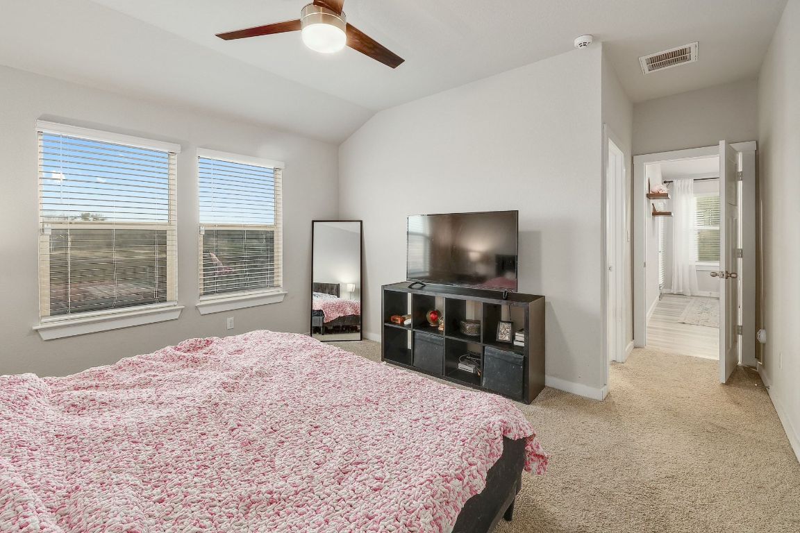 204 Halford Road Georgetown, TX 78633 - Photo 14 of 27 a bedroom with a bed and a flat screen tv