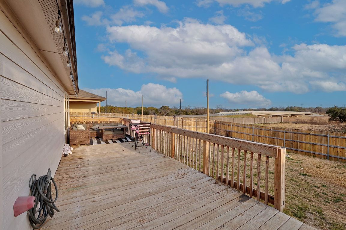 204 Halford Road Georgetown, TX 78633 - Photo 22 of 27 a view of roof deck with two couches and wooden floor