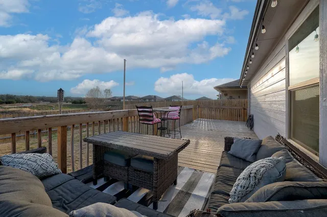 a view of roof deck with two couches and wooden floor