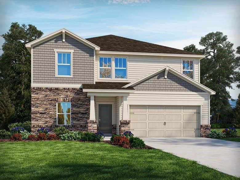 a front view of a house with a garden and yard