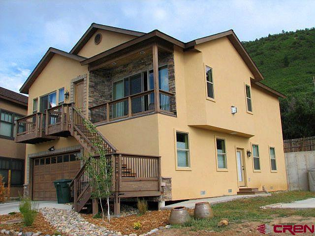 406 Jenkins Ranch Road Durango, CO 81301 - Photo 1 of 1 a view of a big house with wooden fence
