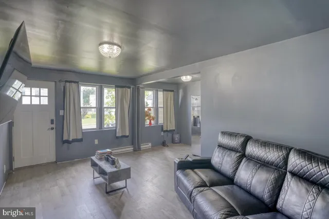 a living room with furniture and large windows