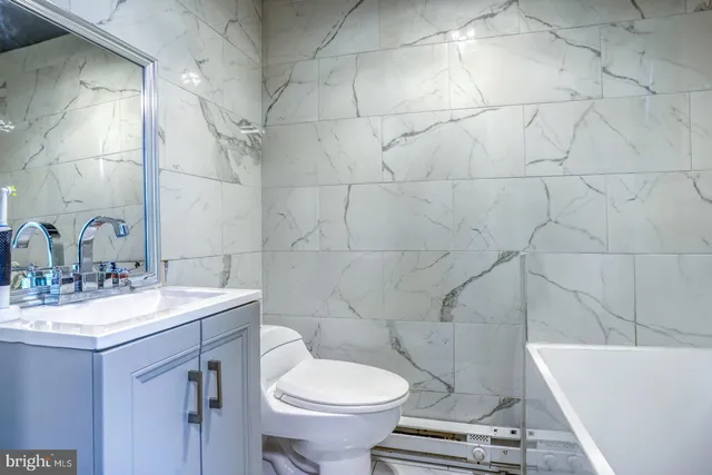 a bathroom with a sink a toilet and a bathtub