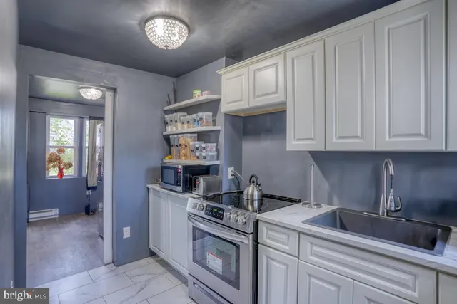 a kitchen with stainless steel appliances granite countertop a sink and cabinets