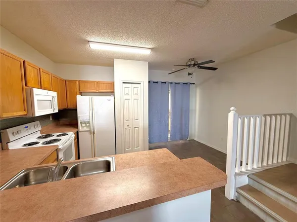 a kitchen with sink refrigerator and window