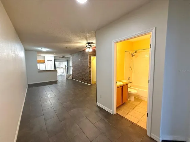 a view of a hallway with furniture and a window