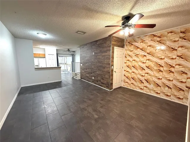 a view of an empty room and window and wooden floor