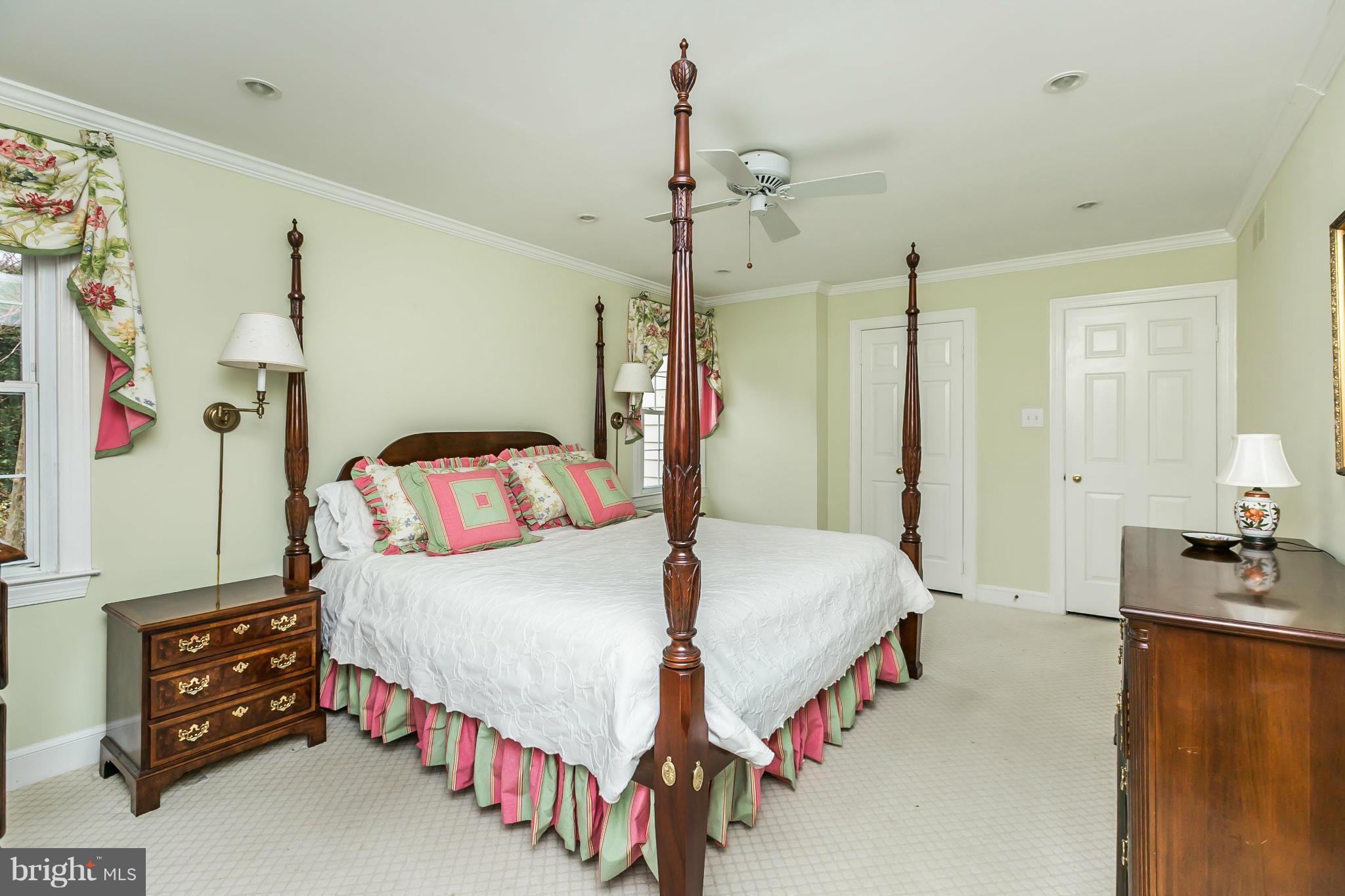 109 Charlesbrooke Road Baltimore, MD 21212 - Photo 18 of 30 a bedroom with a bed a dresser and potted plants