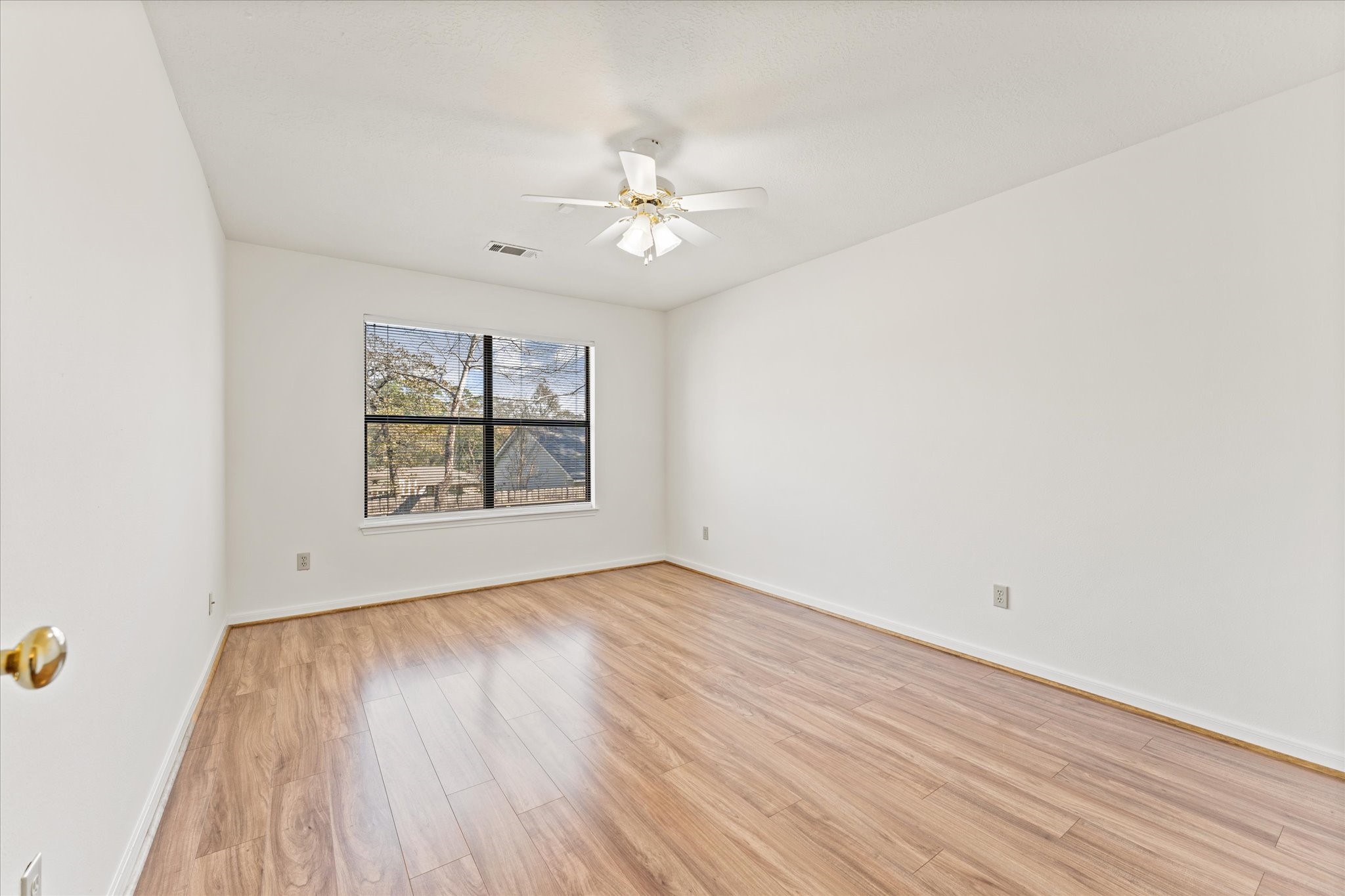 215 Deep Dale Lane Conroe, TX 77304 - Photo 26 of 34 View of second bedroom; ceiling fans & blinds are already installed.