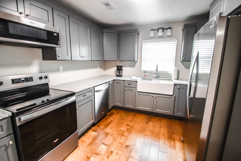 244 West Bockman Way Sparta, TN 38583 - Photo 14 of 23 a kitchen with stainless steel appliances a sink cabinets and a wooden floor