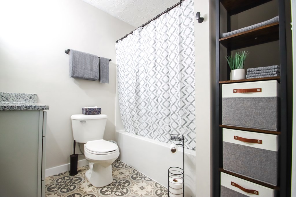 244 West Bockman Way Sparta, TN 38583 - Photo 19 of 23 a white toilet sitting next to a shower curtain