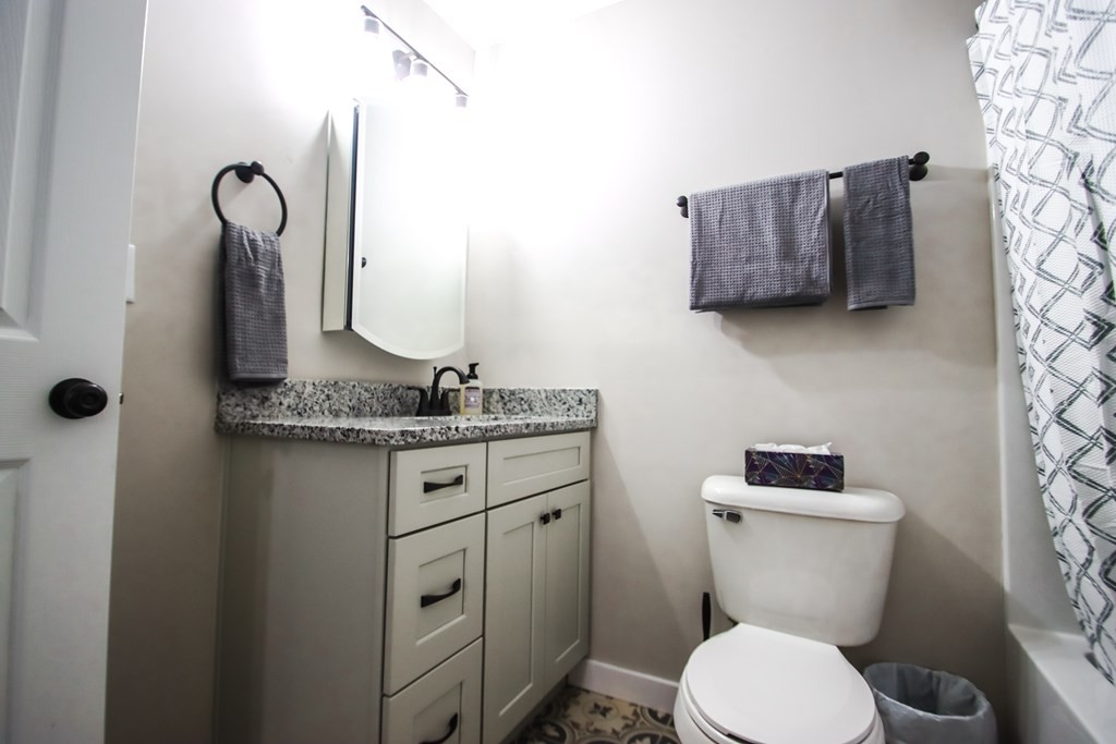 244 West Bockman Way Sparta, TN 38583 - Photo 20 of 23 a bathroom with a granite countertop toilet sink and mirror