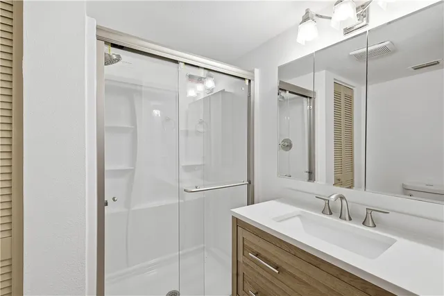 a white toilet sitting next to a bathroom sink