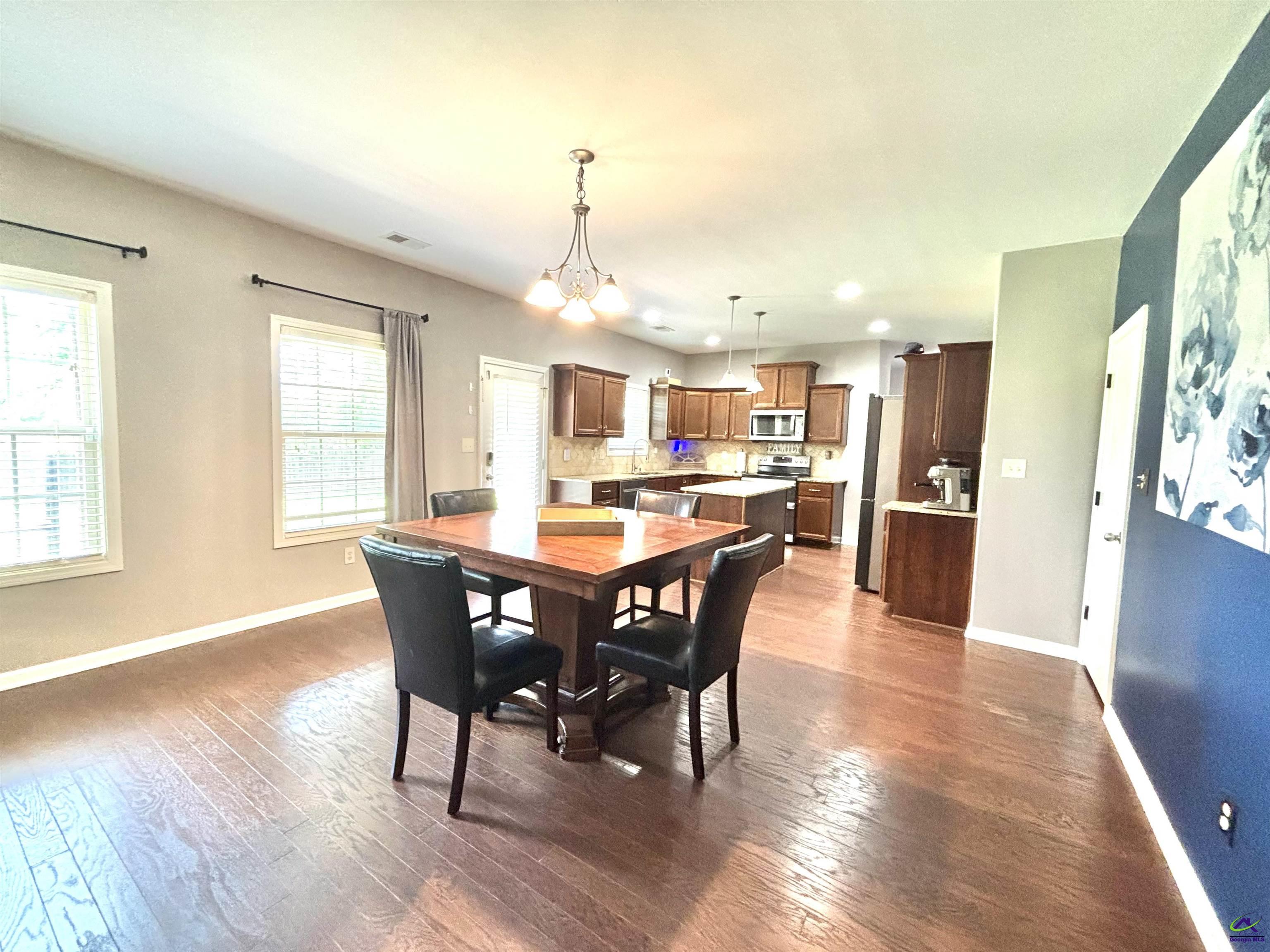 600 Post Oak Way Warner Robins, GA 31088 - Photo 16 of 50 a view of a dining room with furniture and wooden floor