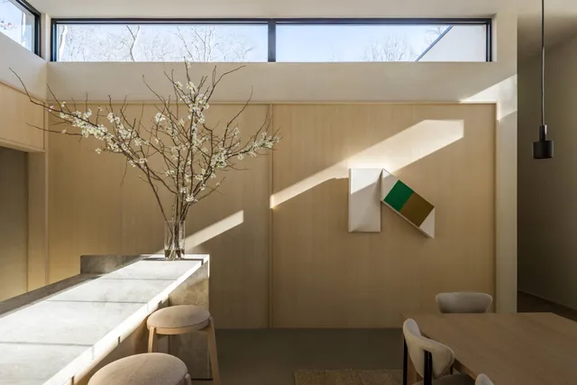 a kitchen with stainless steel appliances kitchen island a table and chairs in it