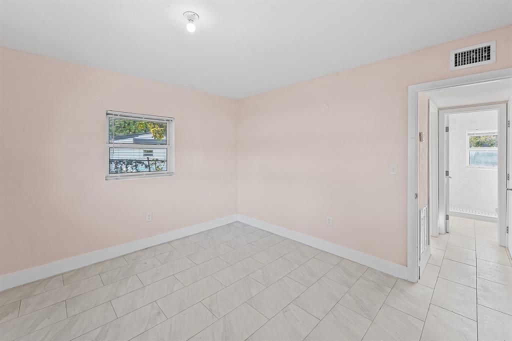 27100 Southwest 144th Avenue Homestead, FL 33032 - Photo 12 of 24 an empty room with a workbench