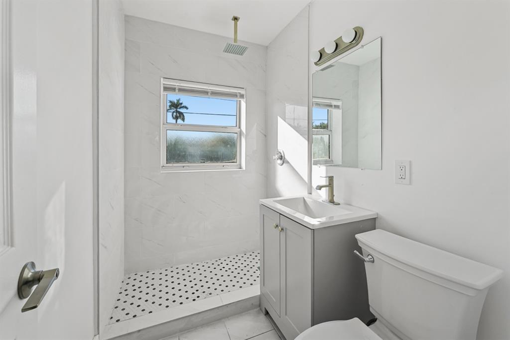27100 Southwest 144th Avenue Homestead, FL 33032 - Photo 13 of 24 a bathroom with a sink toilet and shower