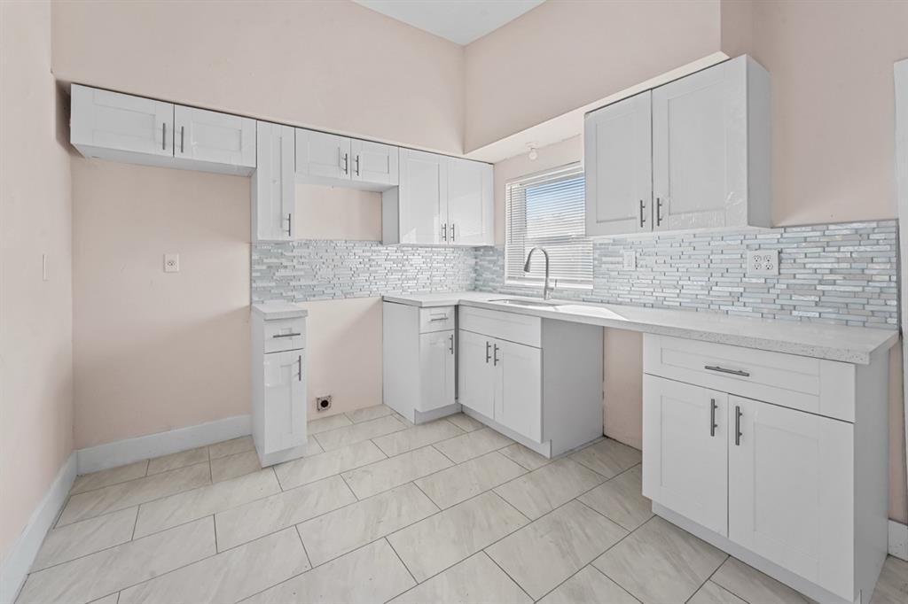 27100 Southwest 144th Avenue Homestead, FL 33032 - Photo 8 of 24 a kitchen with a sink cabinets and window