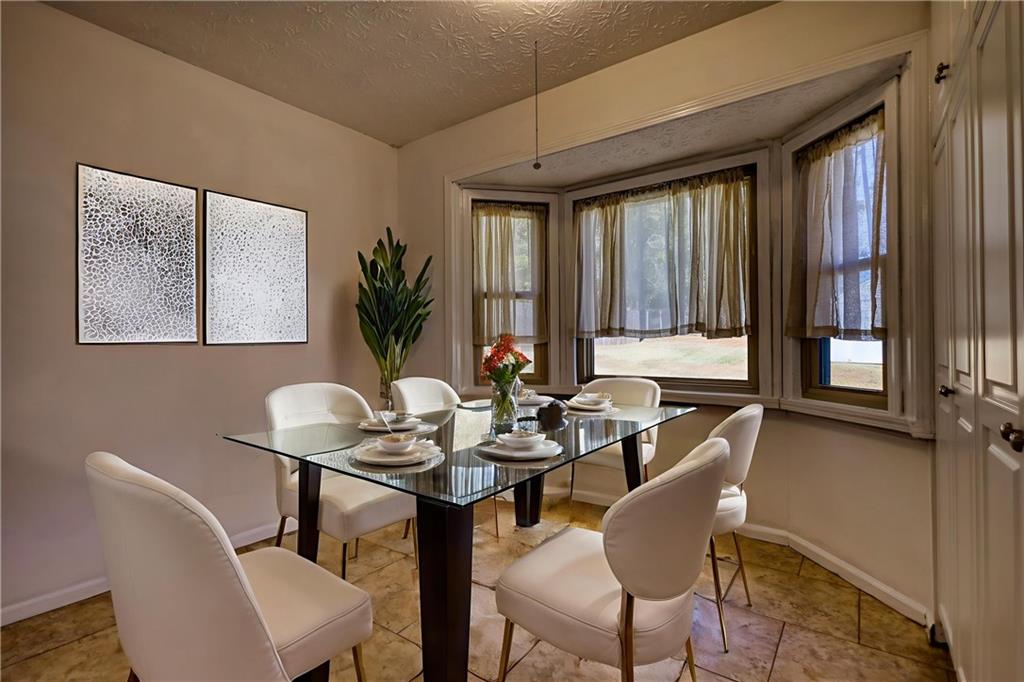 5113 Brownlee Road Southwest Lilburn, GA 30047 - Photo 11 of 48 a dining room with furniture and window