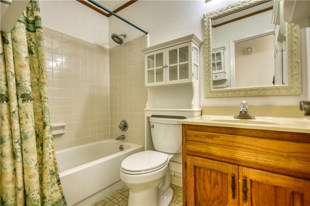5113 Brownlee Road Southwest Lilburn, GA 30047 - Photo 18 of 48 a bathroom with a sink a toilet and shower