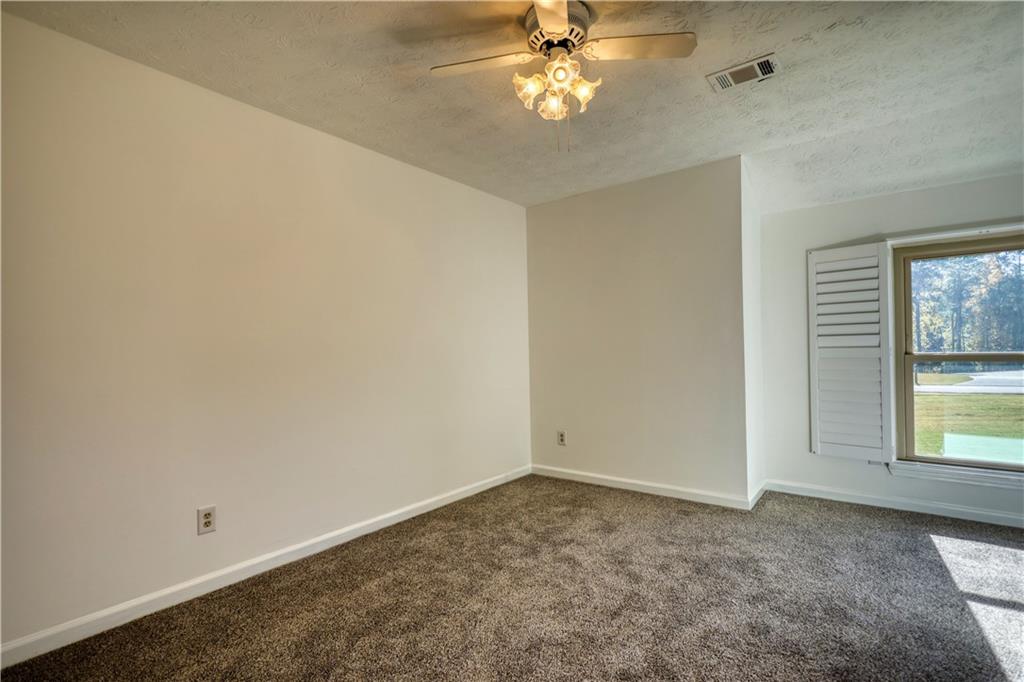 5113 Brownlee Road Southwest Lilburn, GA 30047 - Photo 20 of 48 an empty room with a window