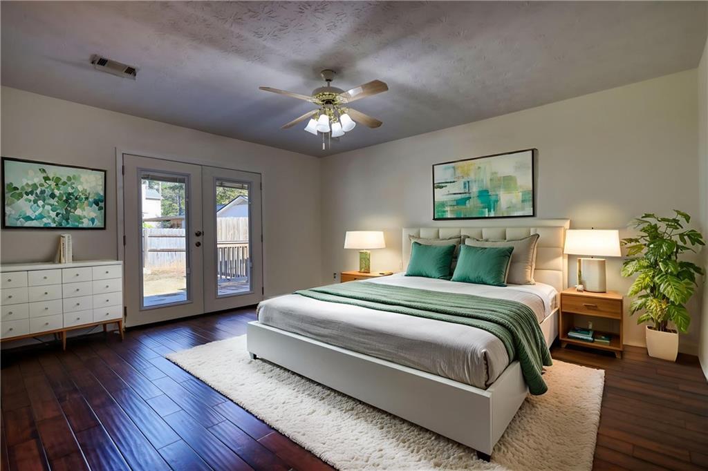 5113 Brownlee Road Southwest Lilburn, GA 30047 - Photo 24 of 48 a bedroom with a large bed chandelier and a window