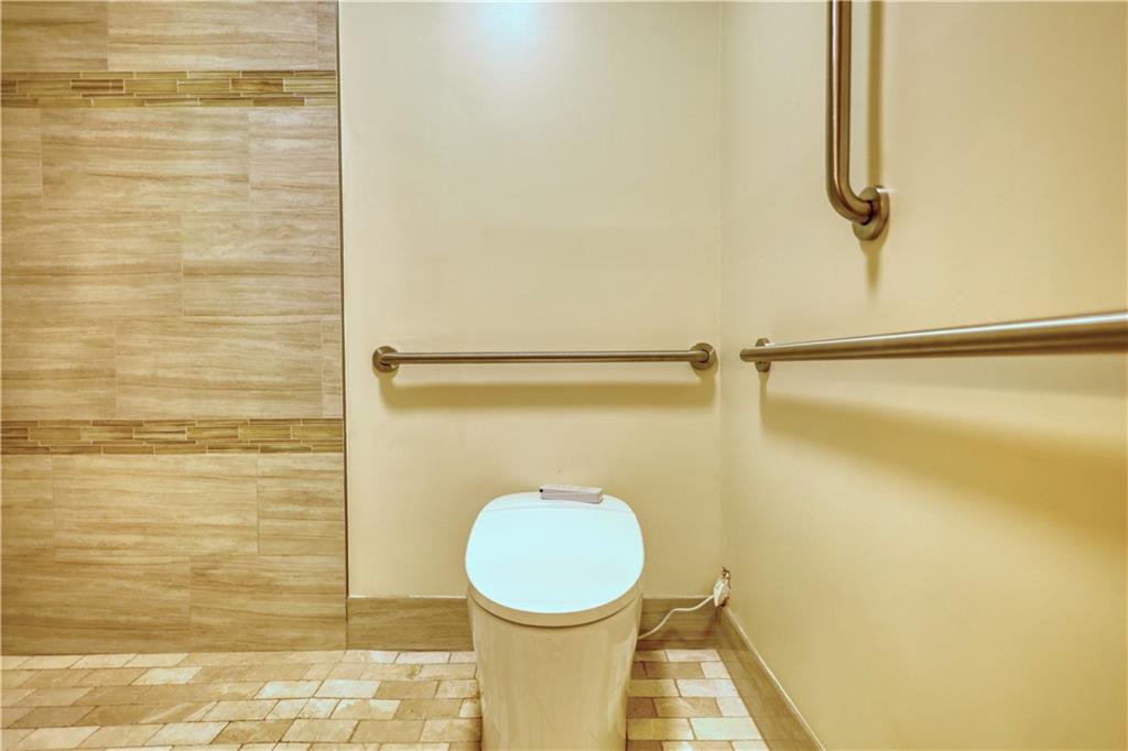 5113 Brownlee Road Southwest Lilburn, GA 30047 - Photo 27 of 48 a bathroom with a toilet and a shower