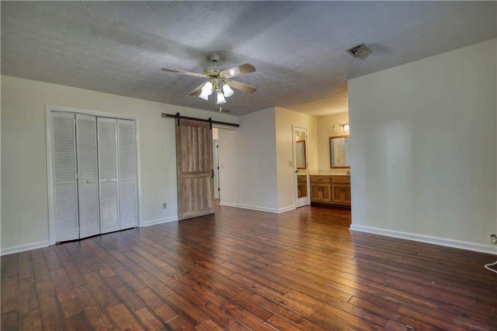 5113 Brownlee Road Southwest Lilburn, GA 30047 - Photo 30 of 48 a view of an empty room with wooden floor